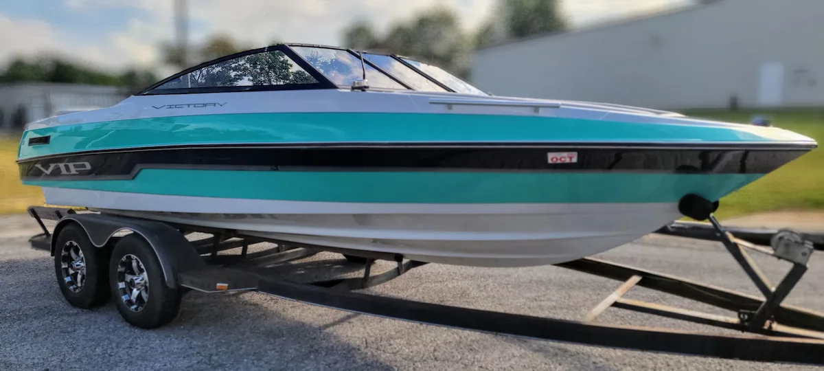 Restored glossy boat hull after marine detailing by Liquid Art Auto Spa